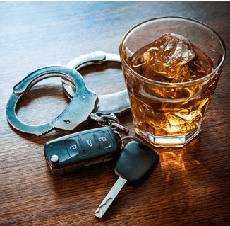 A pair of handcuffs next to an alcoholic beverage and a pair of car keys 